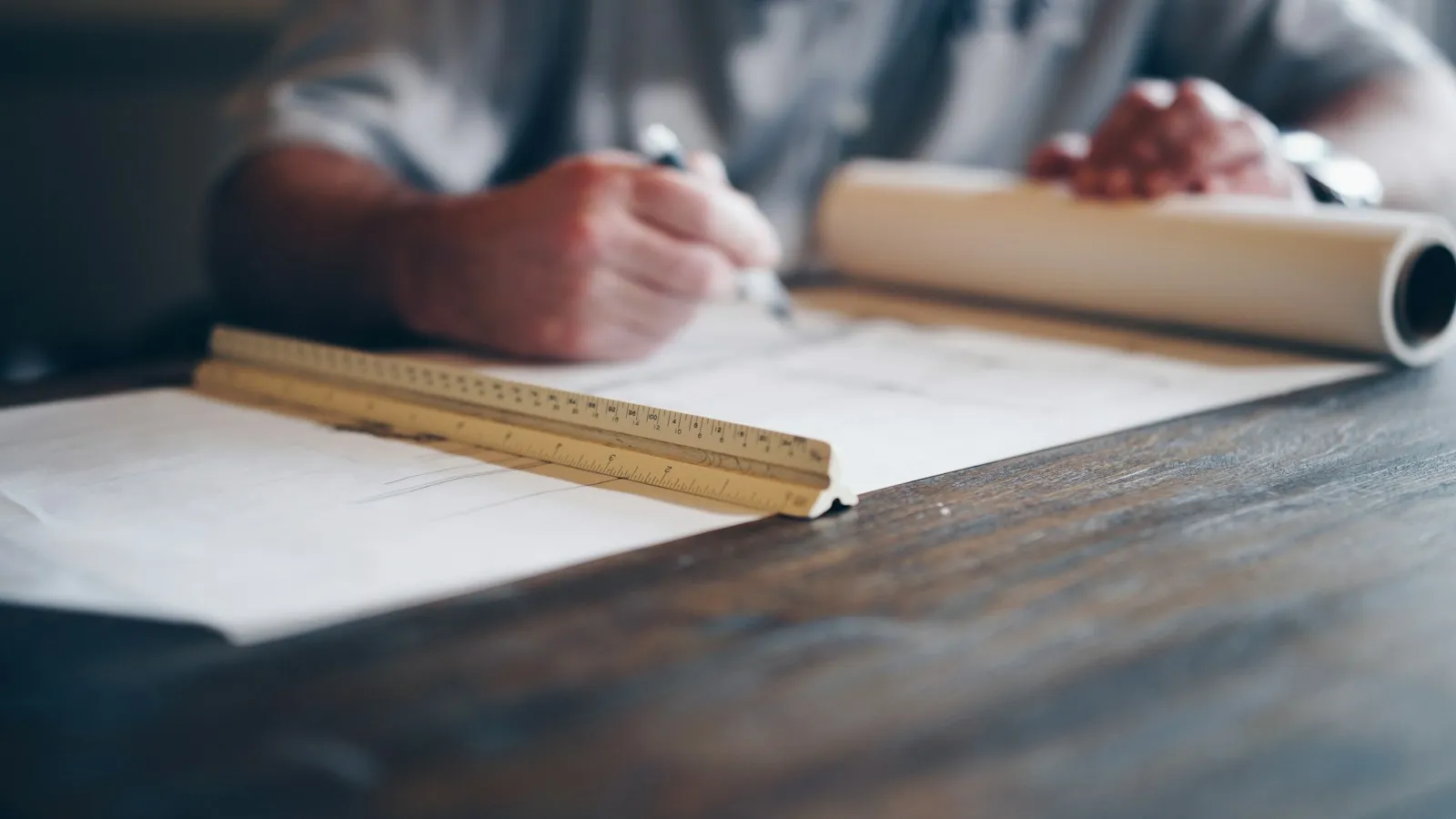 Estimator working over a set of drawings with a scale rule